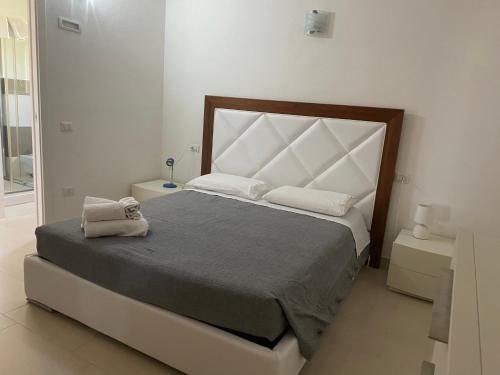 a bedroom with a large bed with two towels on it at villetta con terrazza in Posada