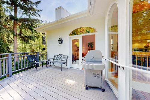 a porch with a bench and chairs on it at Silver Lake Splendor in Oak Harbor
