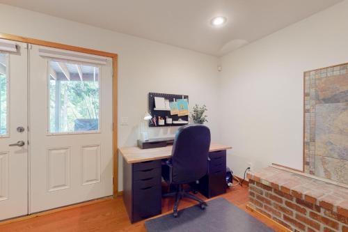 a room with a desk with a computer and a chair at Silver Lake Splendor in Oak Harbor