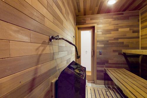 a room with a wooden wall with a shower and a bench at Silver Lake Splendor in Oak Harbor