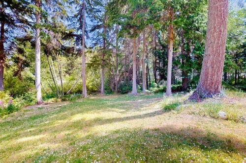 a field of grass with trees in the background at Silver Lake Splendor in Oak Harbor