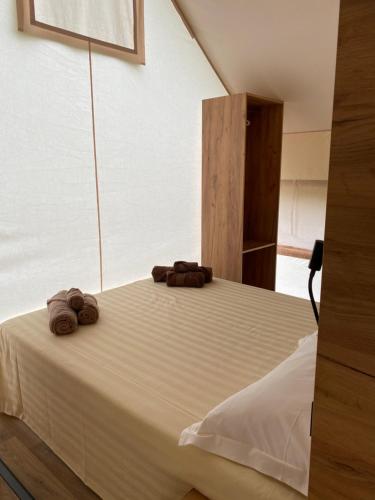 a bedroom with a bed with two towels on it at Agriturismo Casa del Principe in Torre Bormida