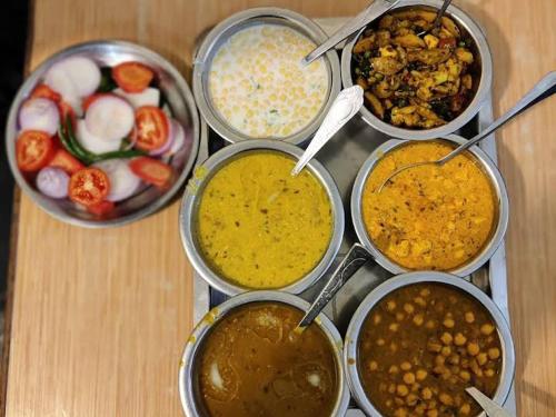 a group of bowls of different types of food at Deelux cottages inn in Chail