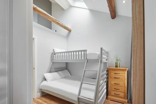 a small bedroom with a bunk bed and a ladder at Host & Stay - The Old Jail Barber's Shop in Seamer