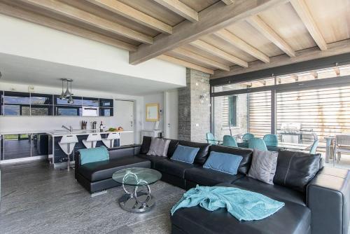a living room with a black couch and a table at Villa Nicolette sleeps 8 in Menaggio
