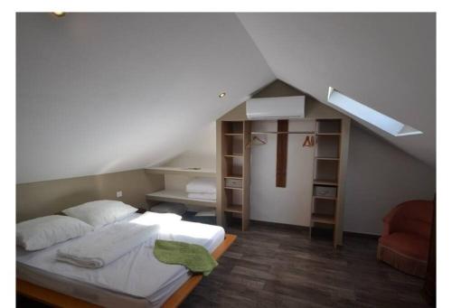 a bedroom with a bed in a attic at Gite La Grange du Pech in Lacour