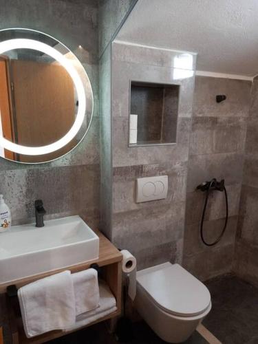 a bathroom with a sink and a toilet and a mirror at Marija in Korčula