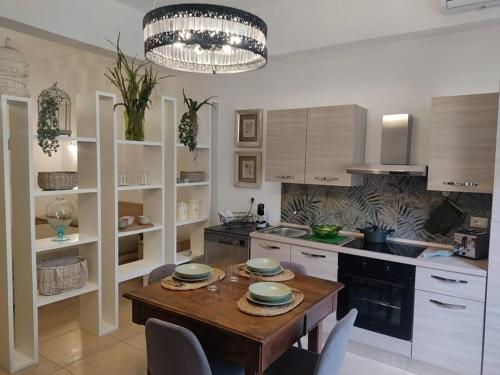 a kitchen with a wooden table and chairs in it at La Casetta di Gio' con Parcheggio in Lerici