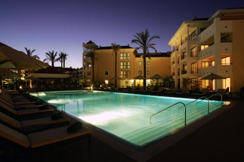 a large swimming pool in front of a building at As Cascatas Golf Resort & Spa in Vilamoura