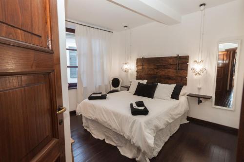 a bedroom with a bed with two black towels on it at Vista Menaggio Centro in Menaggio