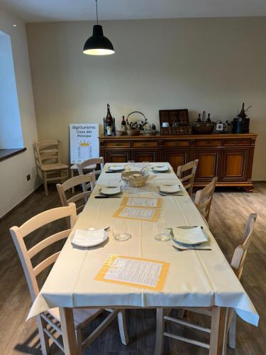 a large table with chairs in a room at Agriturismo Casa del Principe in Torre Bormida