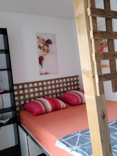 a bedroom with a bunk bed with red pillows at Le Loft in Montpellier