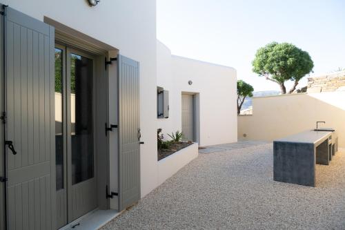 a view of the entrance to a house with a bench at Youtopia Ios Villas in Ios Chora