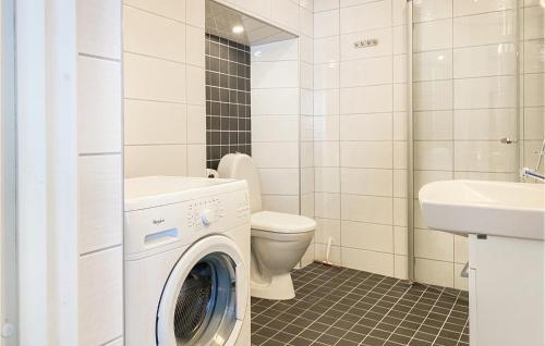 a bathroom with a washing machine and a toilet at Cozy Apartment In Visby With Wifi in Visby
