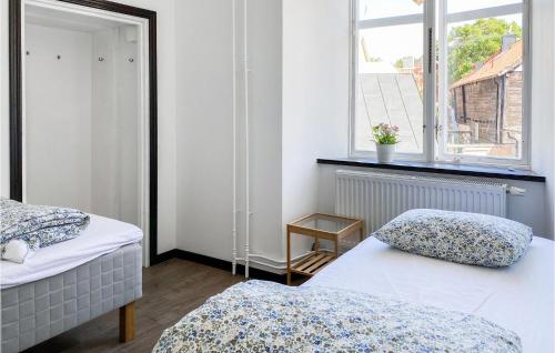 a bedroom with two beds and a window at Cozy Apartment In Visby With Wifi in Visby