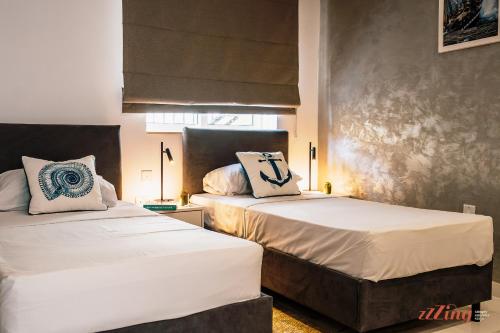 En eller flere senge i et værelse på CapriGem A luxury villa by the sea