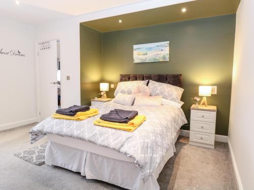 a bedroom with a large bed with two towels on it at Kingfisher Lodge in Great Yarmouth