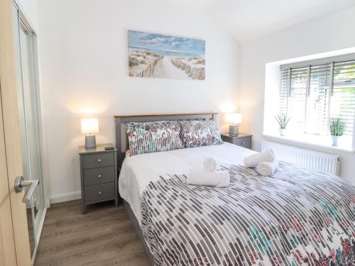 a bedroom with a bed with two pillows on it at Tan Llech in Harlech