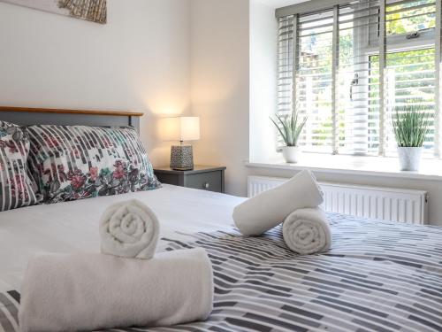 a bedroom with a bed with towels on it at Tan Llech in Harlech