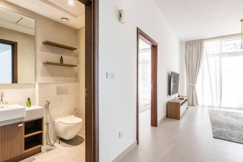 a bathroom with a toilet and a sink and a mirror at 1 Bed Near Zabeel-Park Shiekh Zayed Rd world-Trade center in Dubai
