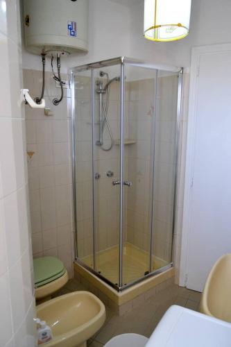 uma casa de banho com um chuveiro, um WC e um lavatório. em Casa Clarissa em Marina di Casalvelino
