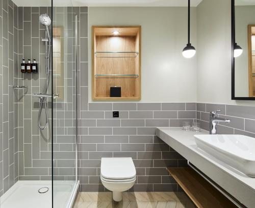 a bathroom with a toilet and a sink and a shower at Residence Inn by Marriott Slough in Slough