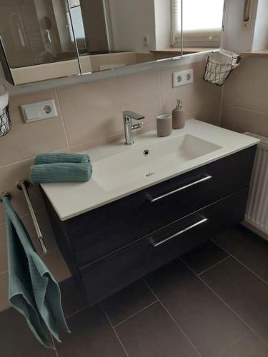 a bathroom with a sink and a mirror at Ferienhaus Weitblick in Olsberg
