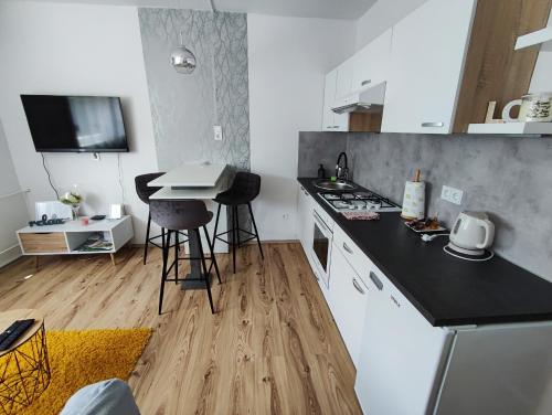 a kitchen with a counter and a table in it at Apartman Emy in Karlovac