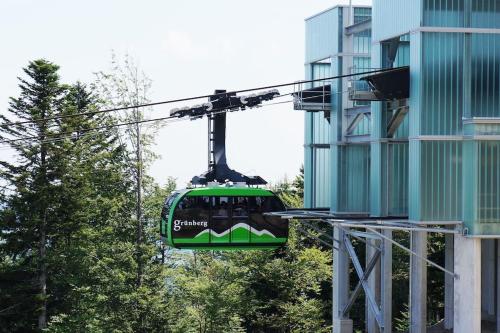 a green tram is riding in front of a building at Gemütliches Haus in Seewalchen am Attersee in Seewalchen