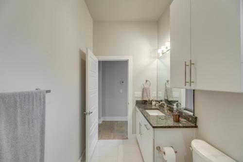 a white bathroom with a sink and a shower at Chic Austin Vacation Rental Condo Near Downtown! in Austin