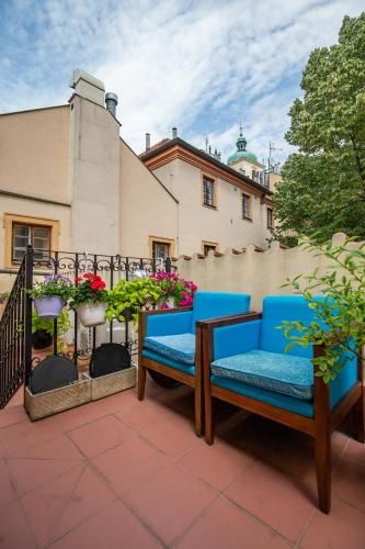 a pair of blue chairs sitting on a patio at Women's Only Hostel - Female Only in Prague