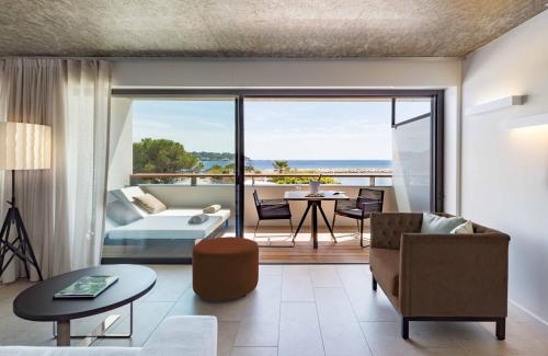 a living room with a view of the ocean at Cap d'Antibes Beach Hotel in Juan-les-Pins