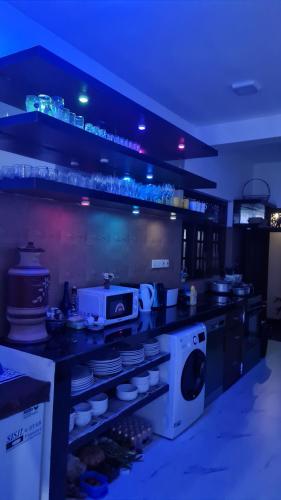 a kitchen with a stove and a washing machine at Villa Talpe in Talpe