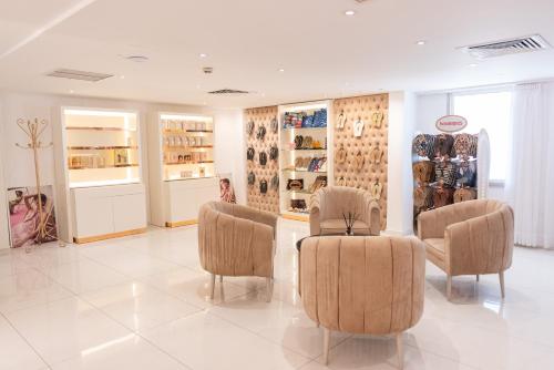 a store with chairs and shelves of shoes at Constantinos the Great Beach Hotel in Protaras