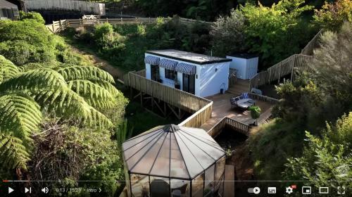 an overhead view of a house with an umbrella at Tiny house with greenhouse dining in Lower Hutt