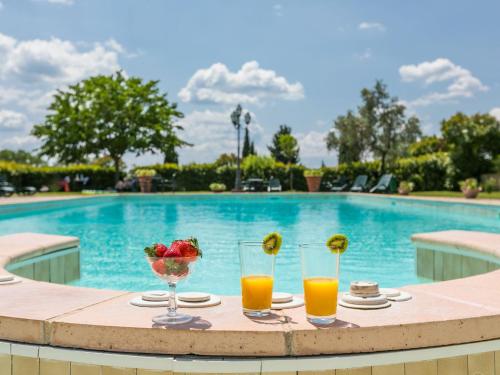una mesa con dos vasos de zumo de naranja y un bol de fruta en Apartment Montereggi-3 by Interhome, en Limite