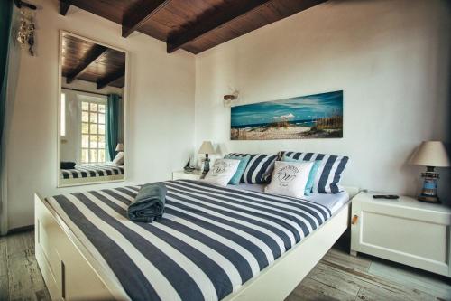 a bedroom with a bed with blue and white stripes at Finca Vino Tinto 1 in Icod de los Vinos