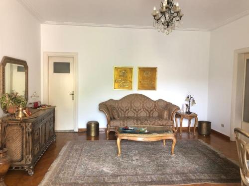 a living room with a couch and a table at Spacious downtown Nile apartment in Cairo
