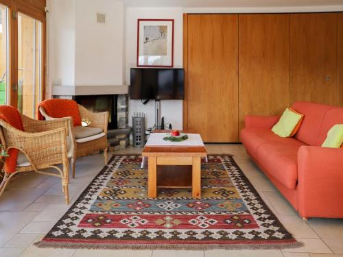 a living room with a red couch and a coffee table at Apartment Domaine des Reines D1A by Interhome in Nendaz