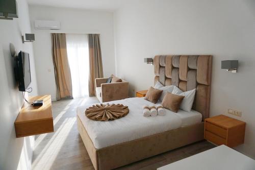 a bedroom with a large bed with two slippers at Hotel Credo in Kotor