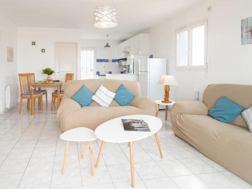 a living room with a couch and a table at Apartment Patguyflor by Interhome in Mimizan-Plage