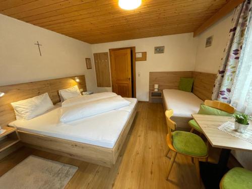 a bedroom with a bed and a table and a desk at Apartment Maria by Interhome in Kappl