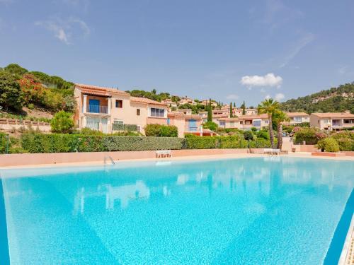 a large blue swimming pool in front of a house at Apartment Les Hauts des Issambres-1 by Interhome in La Garonnette-Plage