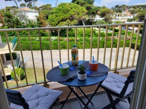 una mesa con una botella y 2 sillas en el balcón en Apartment La Bouée by Interhome, en Antibes