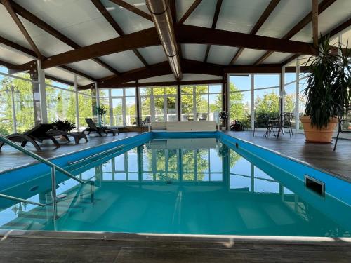 an indoor swimming pool with a large ceiling at Holiday Home Erzeberg-3 by Interhome in Balhorn