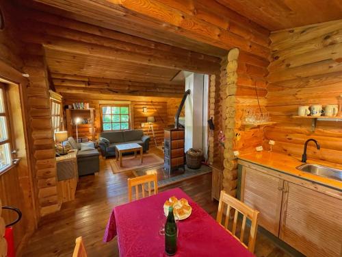 a kitchen and living room with a table in a cabin at Chalet Birdieferienhaus by Interhome in Leisel