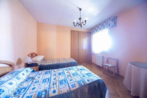 a hotel room with two beds and a window at Las Retamas, Alcorcón in Alcorcón