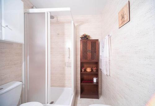 a white bathroom with a shower and a toilet at Las Retamas, Alcorcón in Alcorcón