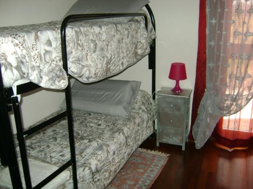 a bedroom with a bunk bed and a table with a lamp at Casa Marblu via Cairoli, 47 Corciano in Corciano