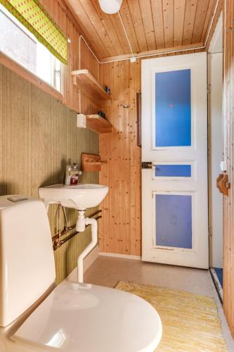a bathroom with a white sink and a door at Holiday Home Ebbabolet by Interhome in Tibro